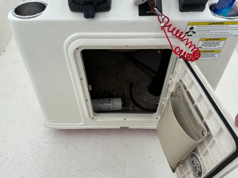 Slide: The Image of Open storage compartment on a 2014 Carolina Skiff 218 DLV boat, showing interior details. - 11