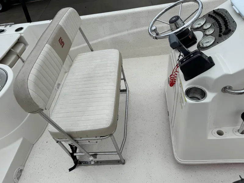 Slide: The Image of 2014 Carolina Skiff 218 DLV boat interior with steering console and seating. - 13