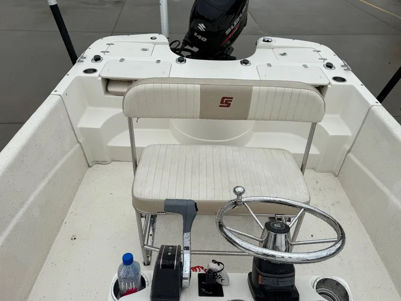 Slide: The Image of 2014 Carolina Skiff 218 DLV boat interior with steering wheel and seating. - 14