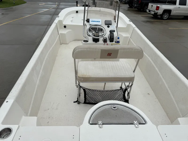 Slide: The Image of 2014 Carolina Skiff 218 DLV boat interior with steering console and seating. - 19