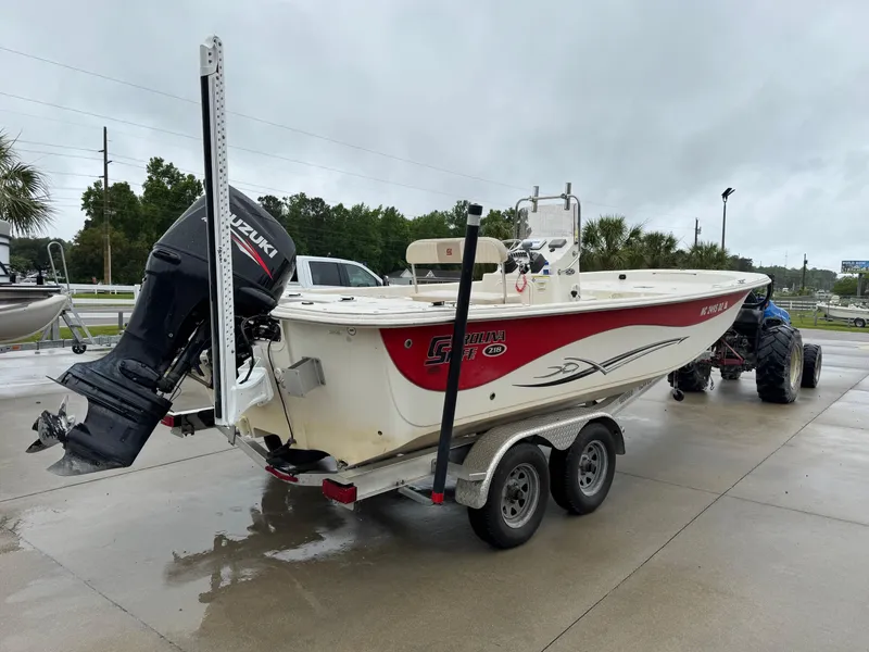 Slide: The Image of 2014 Carolina Skiff 218 DLV boat on trailer with Suzuki outboard motor. - 6