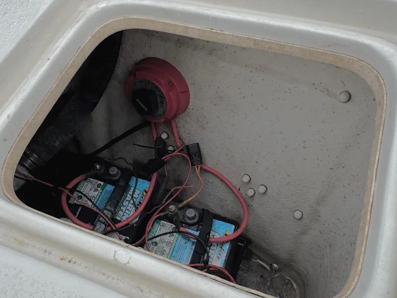 Slide: The Image of Battery compartment of a 2014 Carolina Skiff 218 DLV boat, showing wiring and connections. - 7