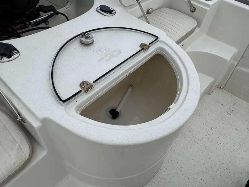 Slide: The Image of 2014 Carolina Skiff 218 DLV boat storage compartment with open lid. - 8