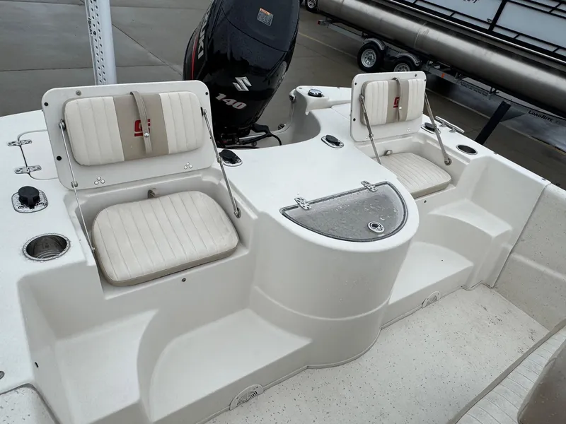 Slide: The Image of 2014 Carolina Skiff 218 DLV boat interior with seating and Suzuki 140 outboard motor. - 9