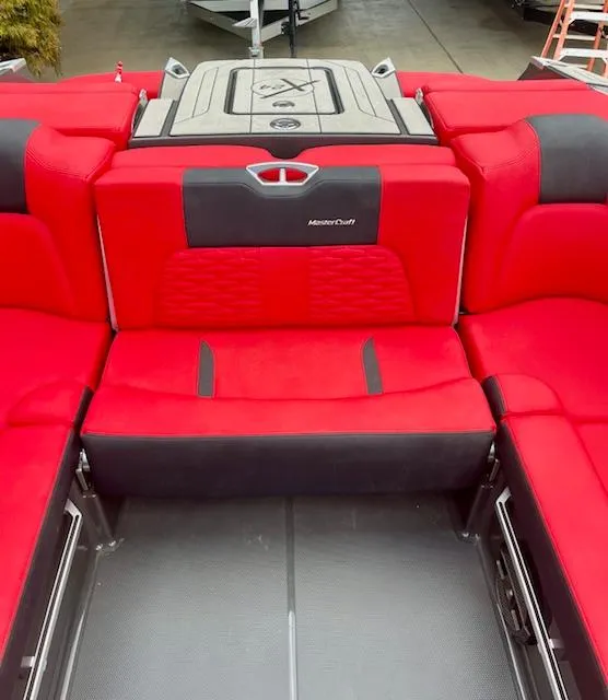 Slide: The Image of 2021 MasterCraft X24 boat interior with vibrant red and black seating. - 14