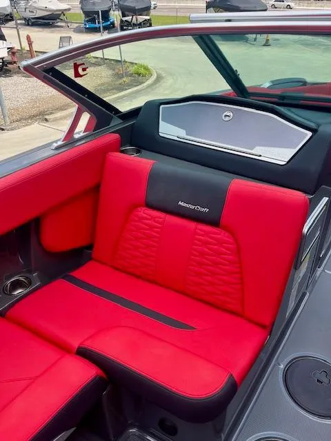 Slide: The Image of Red and black interior of 2021 MasterCraft X24 boat, featuring luxurious seating. - 15