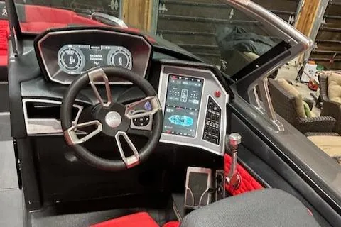 Slide: The Image of 2021 MasterCraft X24 boat dashboard with modern controls and steering wheel. - 22