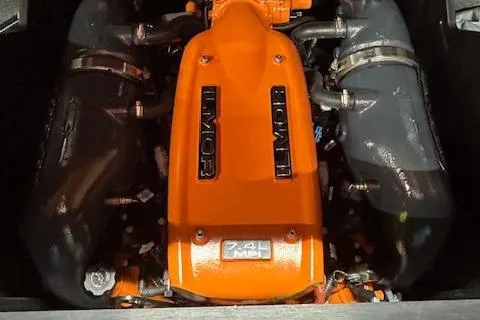 Slide: The Image of 2021 MasterCraft X24 Ilmor 7.4L engine, vibrant orange cover, powerful marine performance. - 23
