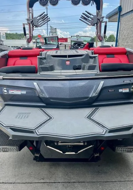 Slide: The Image of 2021 MasterCraft X24 boat with red seating and sleek design, rear view. - 6