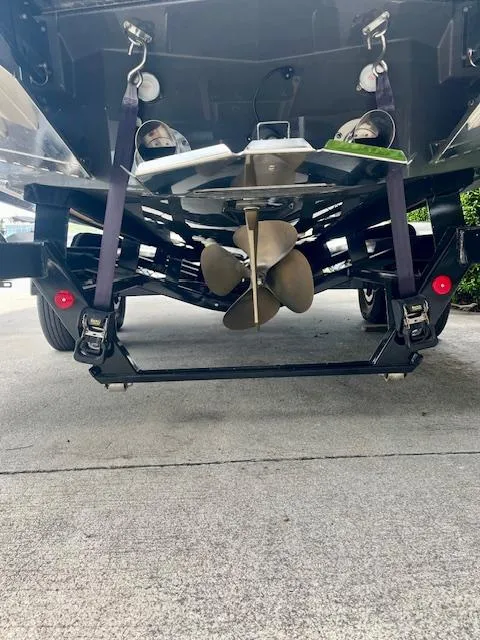 Slide: The Image of Rear view of 2021 MasterCraft X24 boat showing propeller and trailer setup. - 8