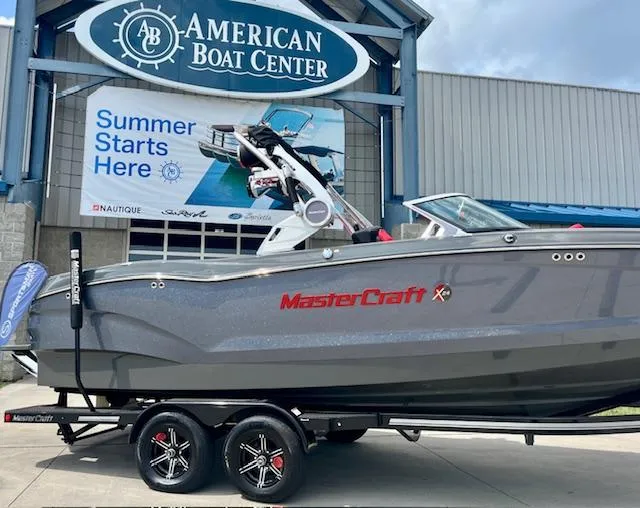 Slide: The Image of 2021 MasterCraft X24 boat displayed at American Boat Center with summer promotion banner. - 9