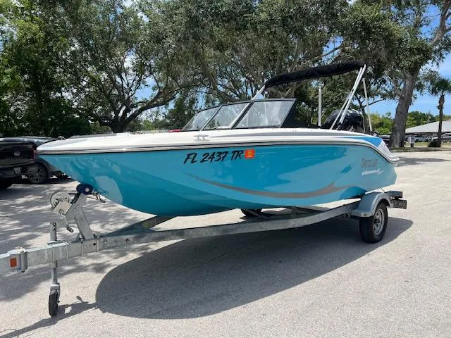 Slide: The Image of 2023 Bayliner Element M17 boat on trailer, parked outdoors. - 1