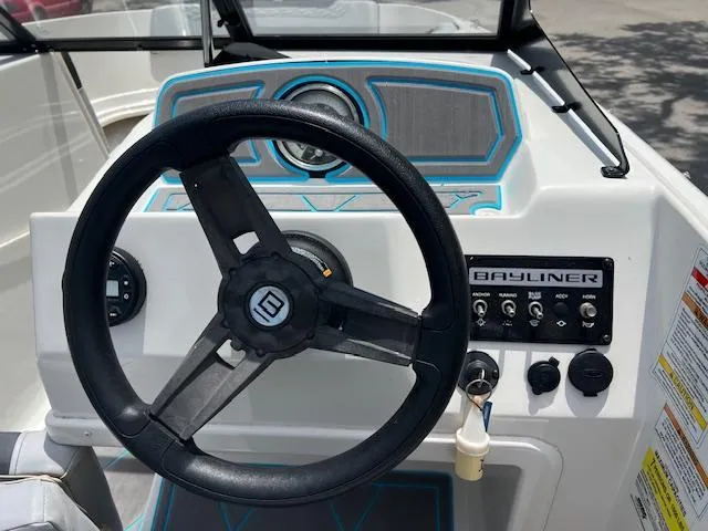 Slide: The Image of 2023 Bayliner Element M17 dashboard with steering wheel and control panel. - 3