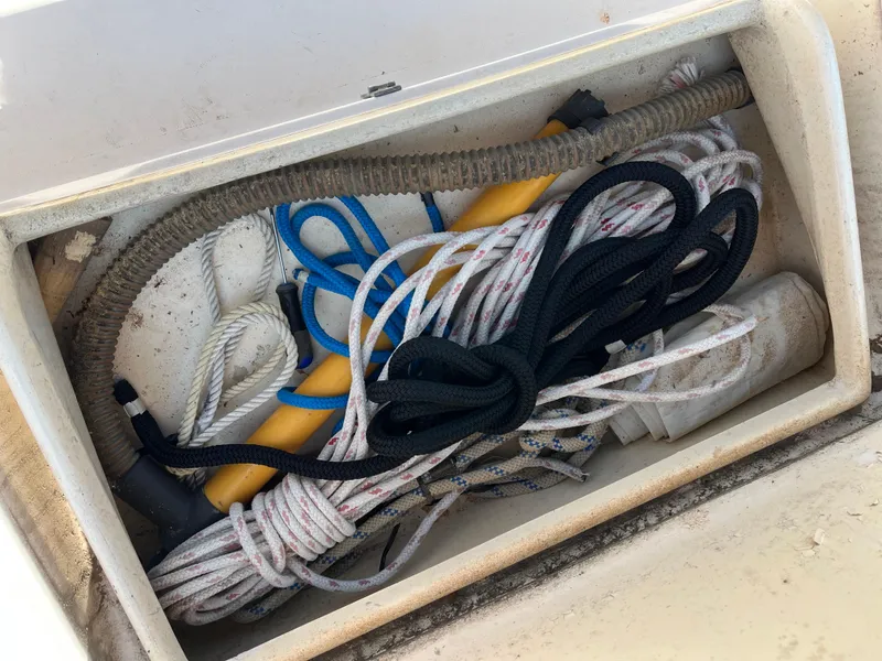 Slide: The Image of Storage compartment with ropes, hose, and tools on a 1978 Bristol 29.9 boat. - 19