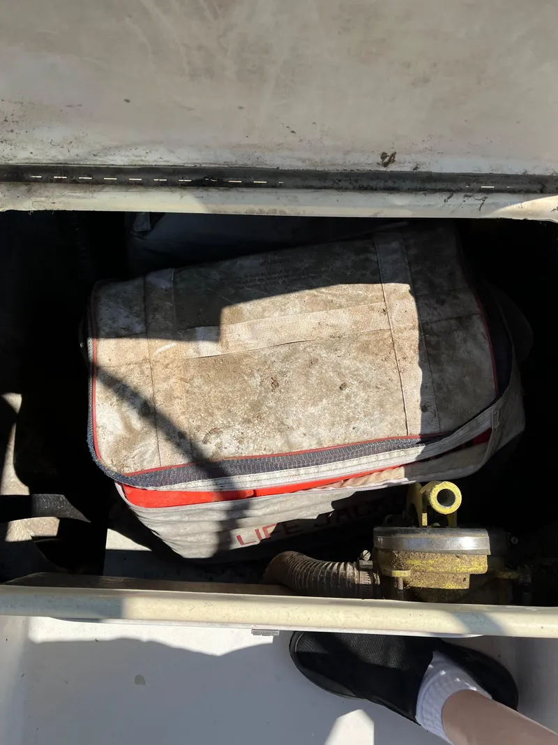Slide: The Image of Dirty bag in a 1978 Bristol 29.9 boat compartment with visible foot. - 20