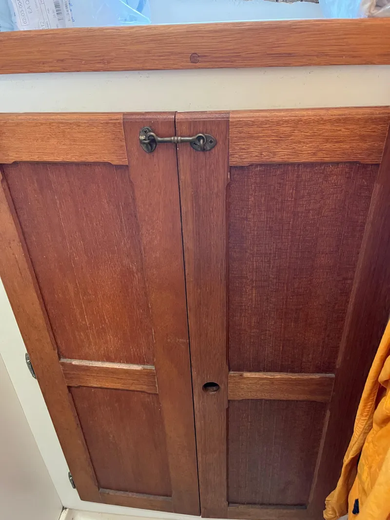 Slide: The Image of Wooden cabinet doors with a latch, part of a 1978 Bristol 29.9 model interior. - 21