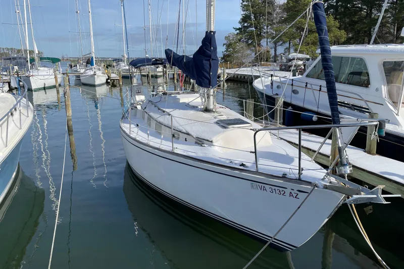 Slide: The Image of 1978 Bristol 29.9 sailboat docked in a marina, surrounded by other boats. - 23