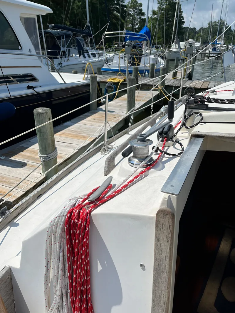 Slide: The Image of 1978 Bristol 29.9 sailboat docked, featuring deck equipment and colorful ropes. - 5