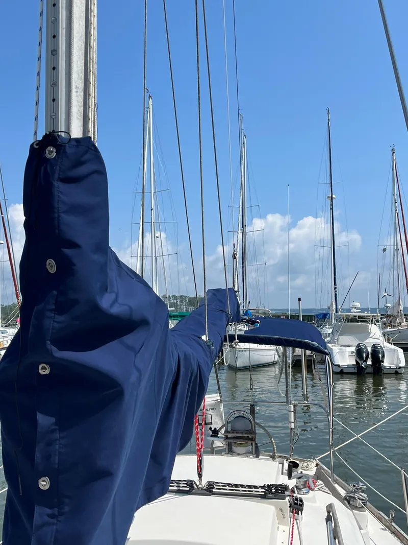 Slide: The Image of Sailboat docked in marina, featuring a 1978 Bristol 29.9 under a clear blue sky. - 7