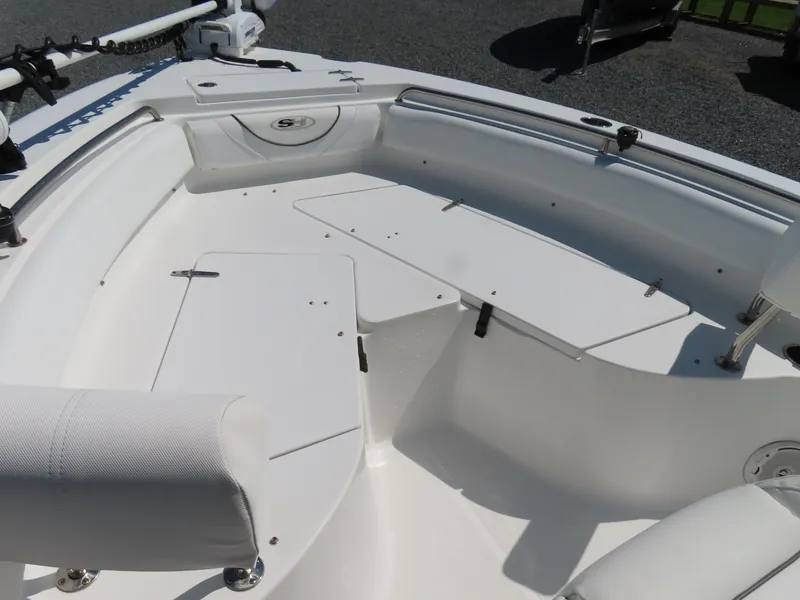Slide: The Image of 2016 Sea Hunt Ultra 234 boat interior with seating and storage compartments. - 11