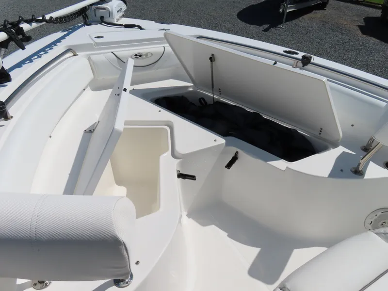 Slide: The Image of 2016 Sea Hunt Ultra 234 boat with open storage compartments and seating. - 12