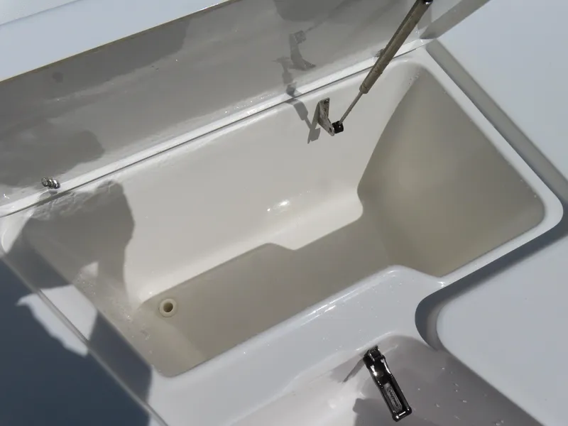 Slide: The Image of Open storage compartment on a 2016 Sea Hunt Ultra 234 boat. - 13