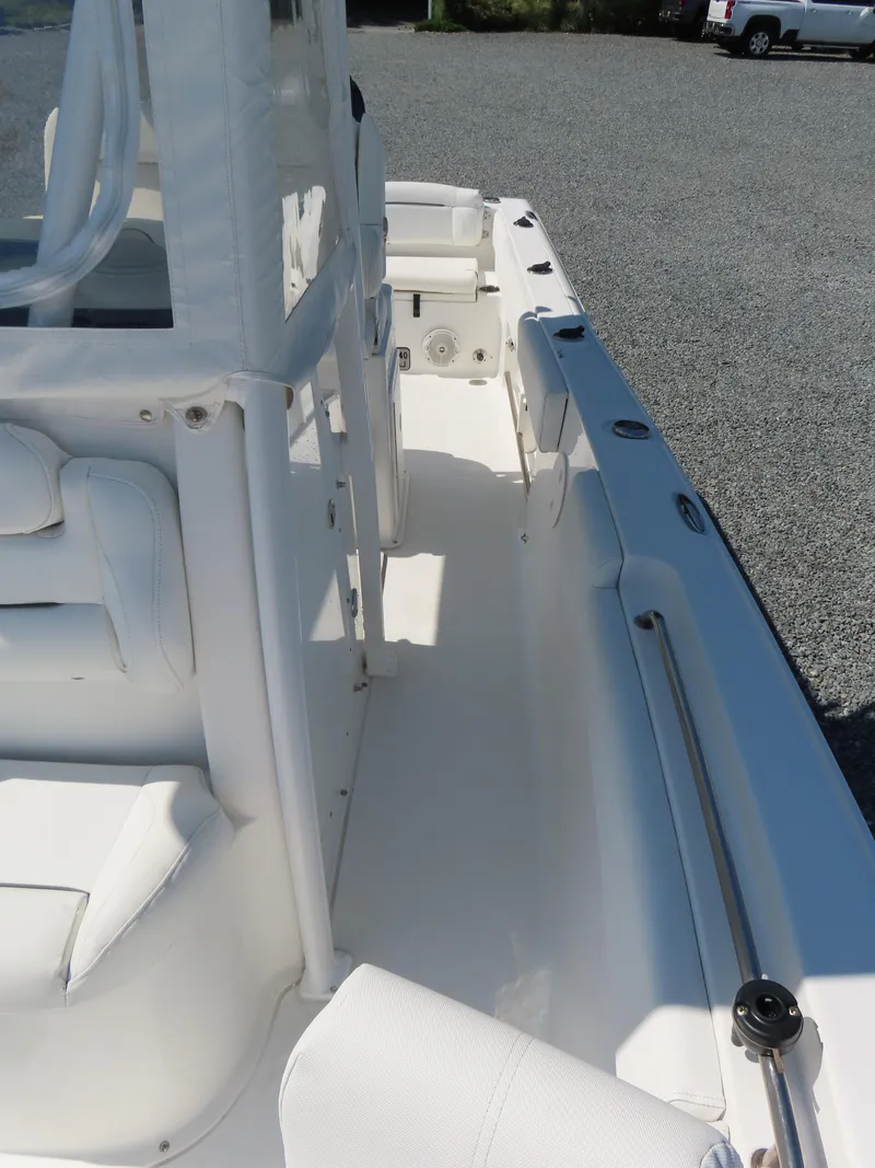 Slide: The Image of 2016 Sea Hunt Ultra 234 boat interior with white seating and console. - 19