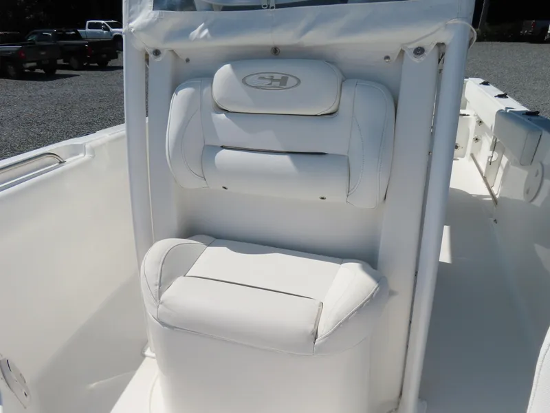 Slide: The Image of 2016 Sea Hunt Ultra 234 boat seat, white upholstery, outdoor setting. - 20