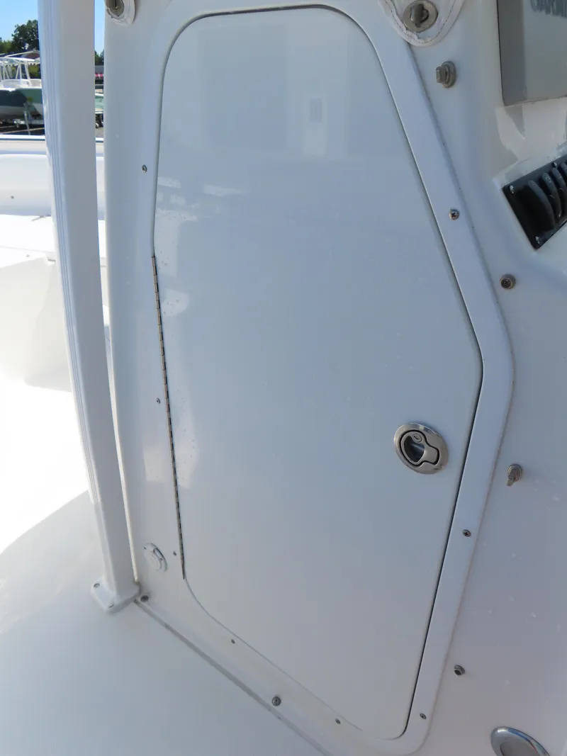 Slide: The Image of 2016 Sea Hunt Ultra 234 boat storage compartment with secure latch. - 22