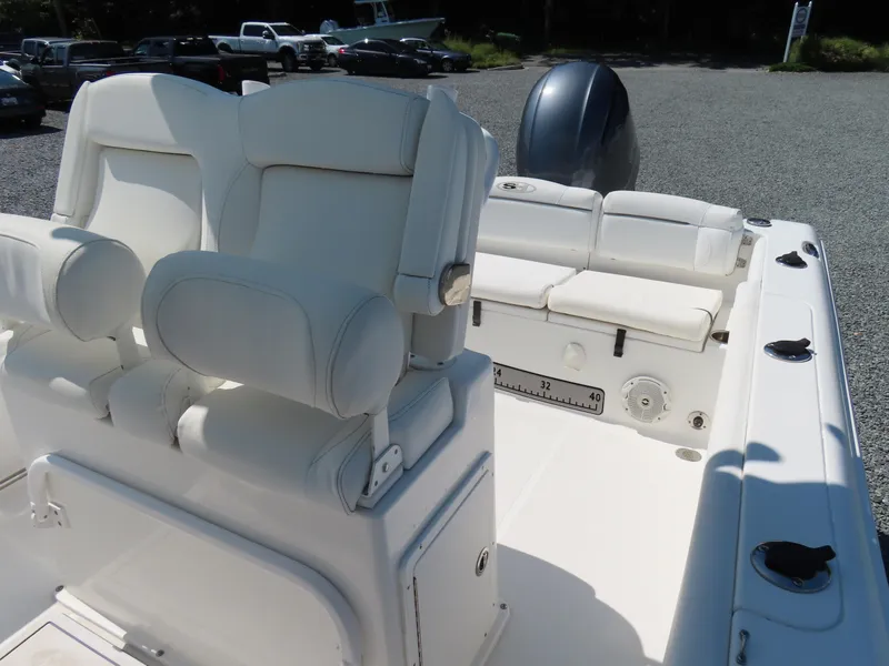 Slide: The Image of 2016 Sea Hunt Ultra 234 boat interior with white seating and fishing rod holders. - 24