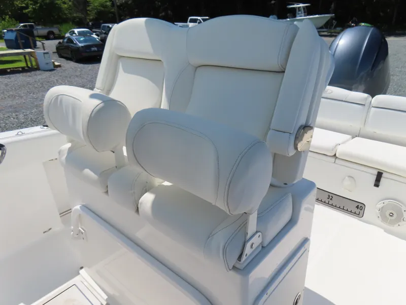 Slide: The Image of 2016 Sea Hunt Ultra 234 boat with white cushioned seating and armrests. - 25