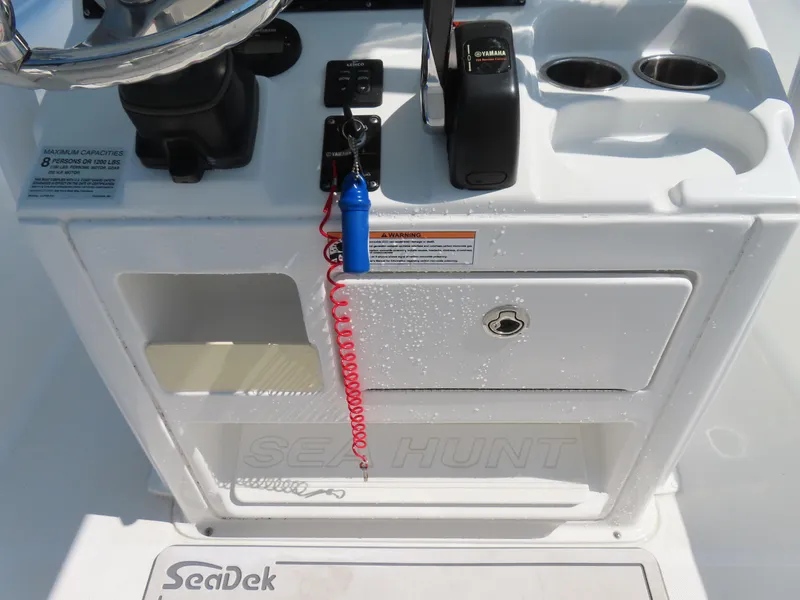 Slide: The Image of Control panel of a 2016 Sea Hunt Ultra 234 boat with steering wheel and throttle. - 29