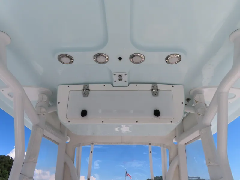 Slide: The Image of 2016 Sea Hunt Ultra 234 boat interior ceiling with lights and storage compartment. - 30