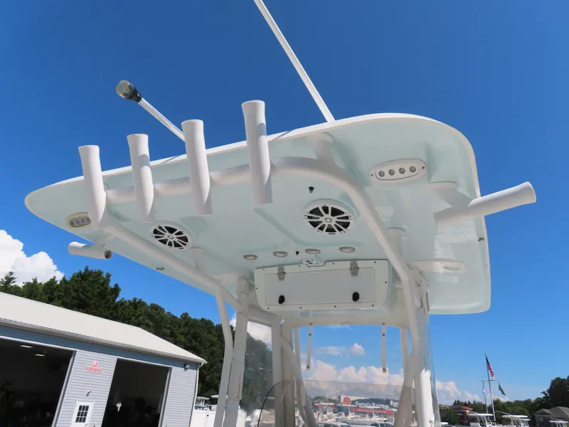 Slide: The Image of 2016 Sea Hunt Ultra 234 boat top view with rod holders and speakers under clear blue sky. - 32