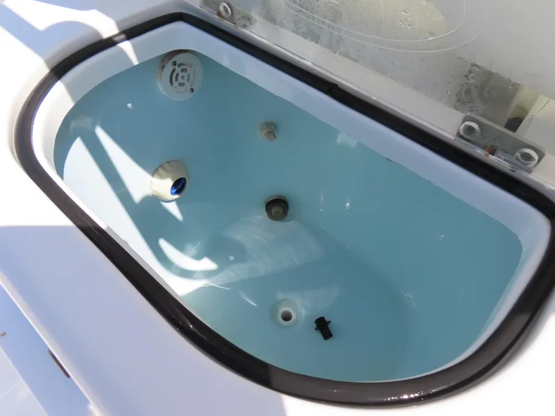 Slide: The Image of Livewell in 2016 Sea Hunt Ultra 234 boat, featuring clean interior and functional components. - 34