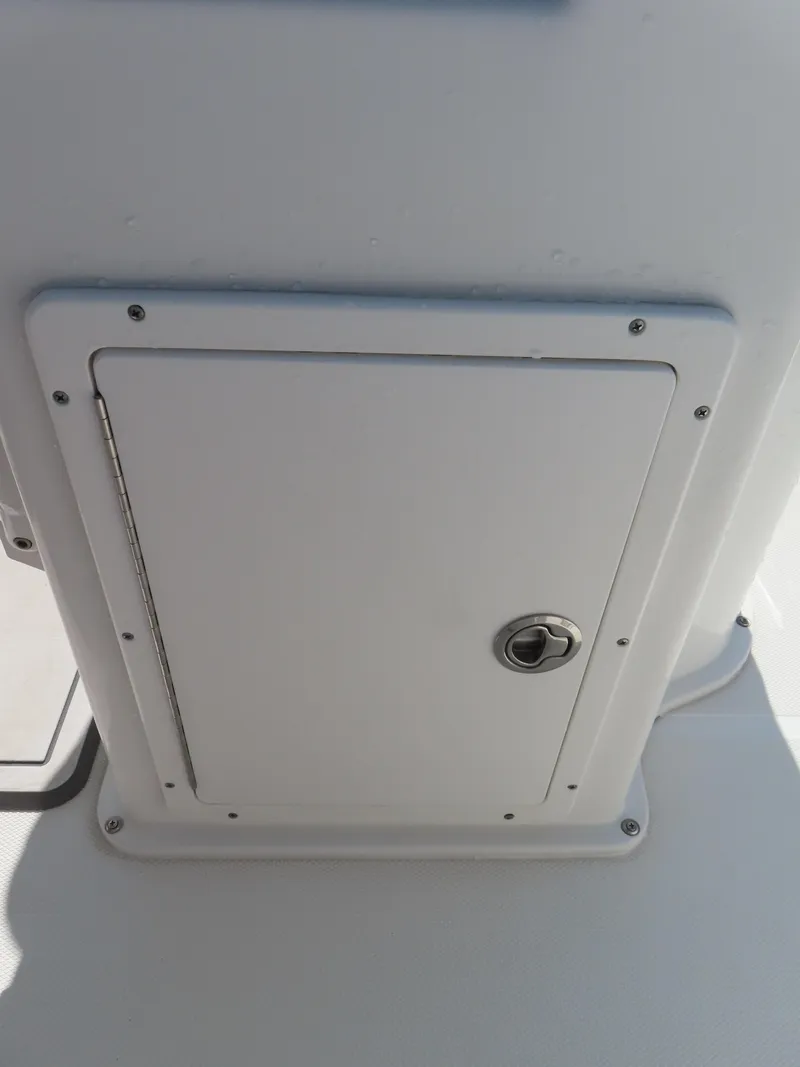 Slide: The Image of 2016 Sea Hunt Ultra 234 boat storage compartment with lock. - 35