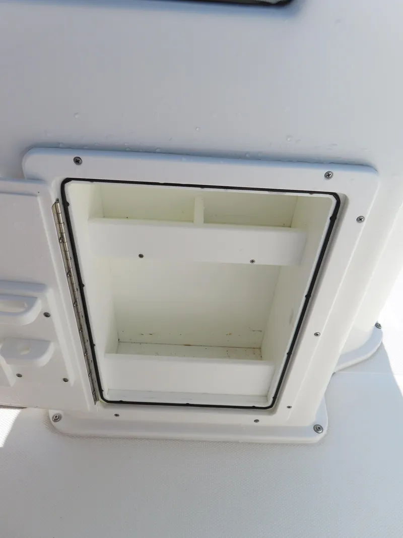 Slide: The Image of Storage compartment on a 2016 Sea Hunt Ultra 234 boat, open and empty. - 36