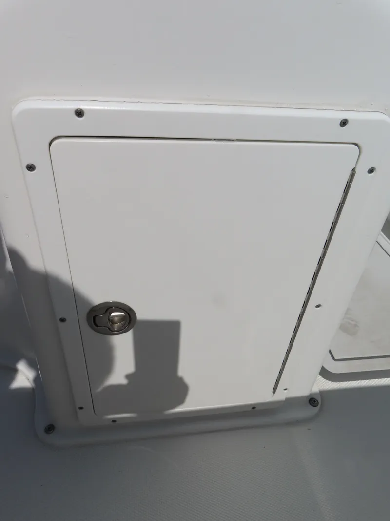 Slide: The Image of White storage compartment on 2016 Sea Hunt Ultra 234 boat. - 37