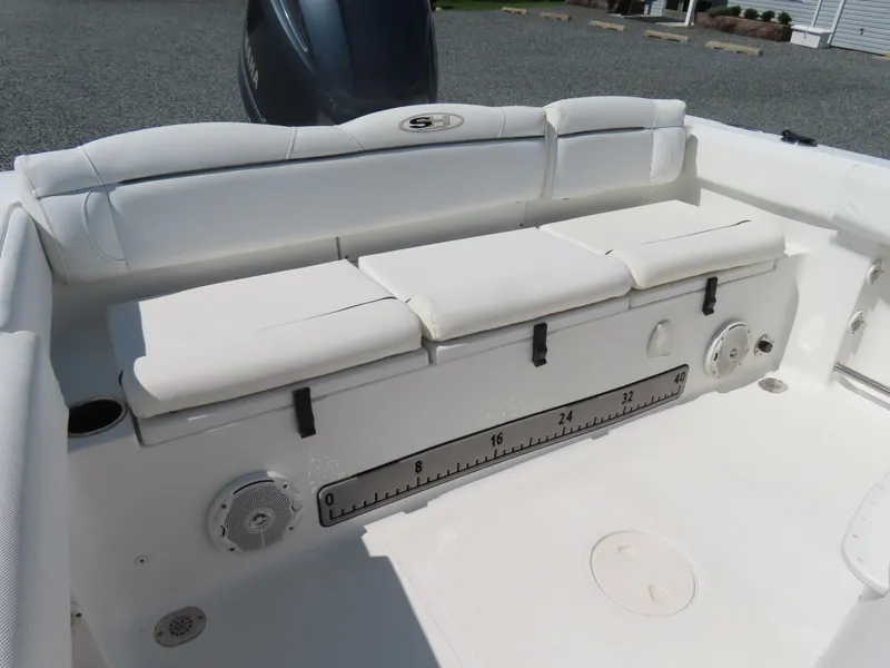 Slide: The Image of 2016 Sea Hunt Ultra 234 boat interior with cushioned seating and measurement scale. - 39