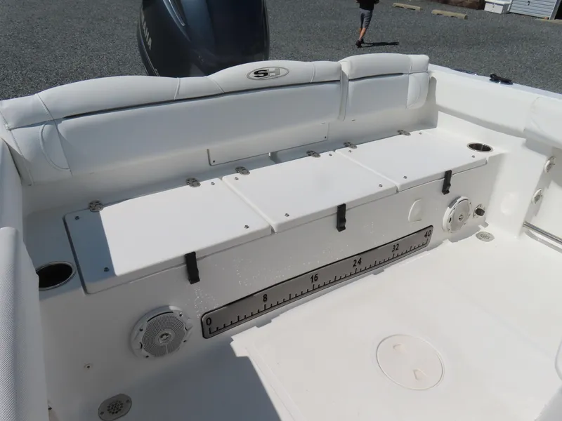Slide: The Image of 2016 Sea Hunt Ultra 234 boat interior with seating and storage compartments. - 40