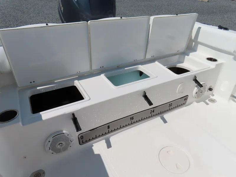 Slide: The Image of 2016 Sea Hunt Ultra 234 boat interior with storage compartments and measuring ruler. - 41