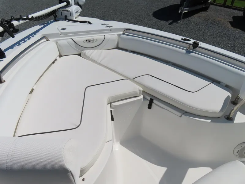 Slide: The Image of 2016 Sea Hunt Ultra 234 boat interior with white cushioned seating. - 7