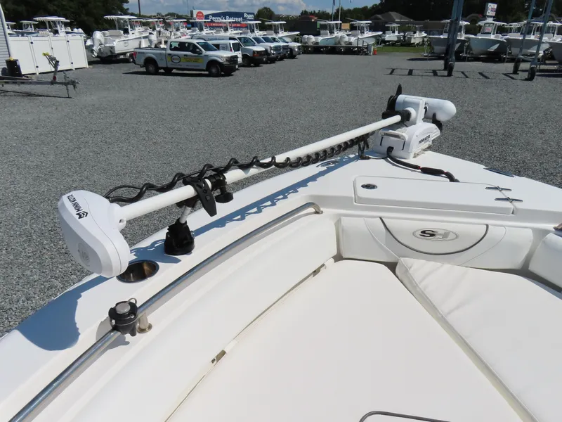 Slide: The Image of 2016 Sea Hunt Ultra 234 boat with Minn Kota trolling motor in a dealership lot. - 8