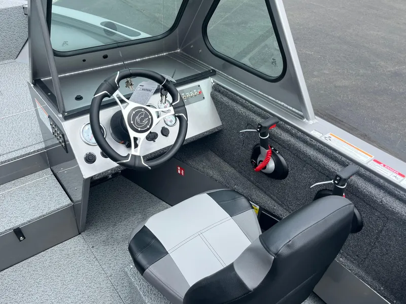 Slide: The Image of 2025 Crestliner 2050 Commander boat interior with steering wheel and seating. - 4