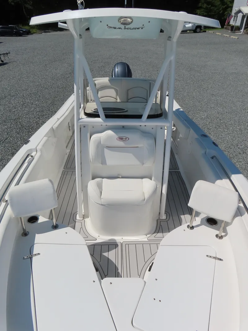 Slide: The Image of 2019 Sea Hunt Ultra 234 boat interior with seating and console, viewed from above. - 12