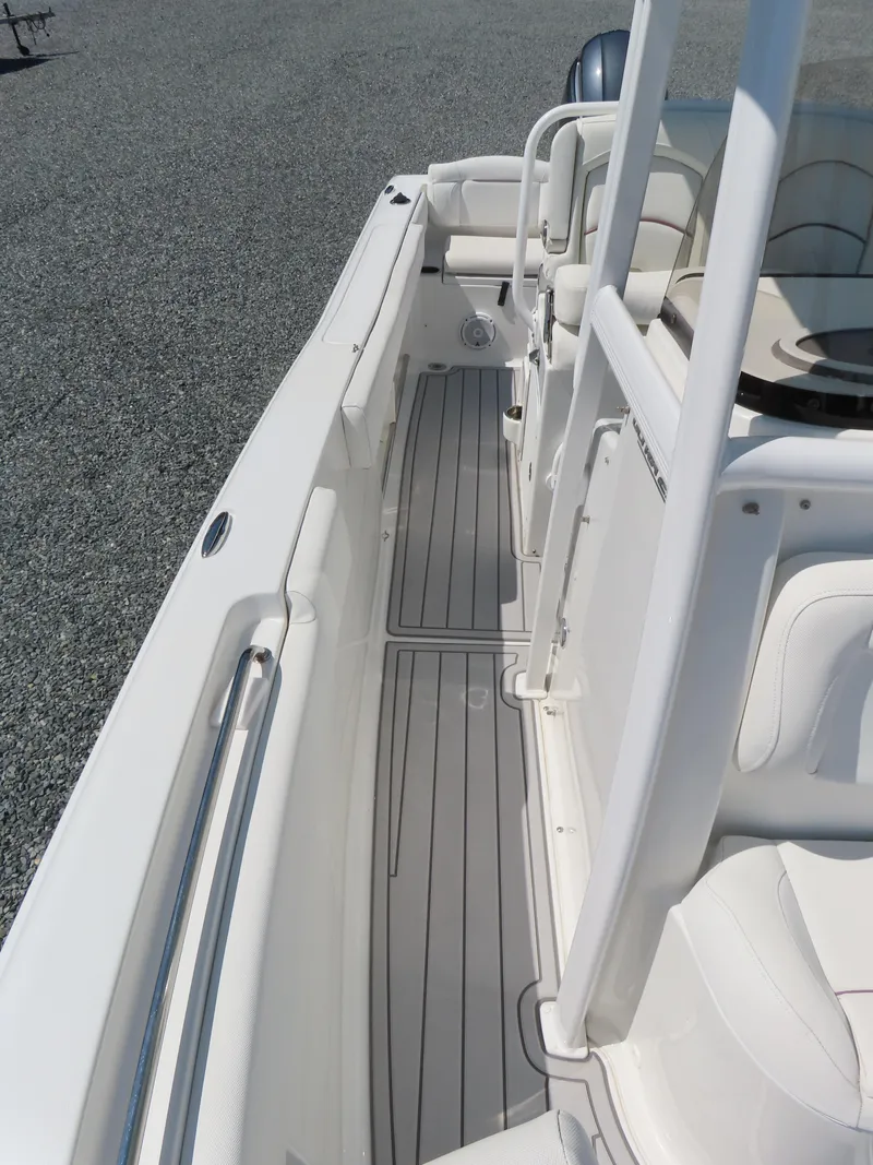 Slide: The Image of 2019 Sea Hunt Ultra 234 boat interior with sleek white seating and gray flooring. - 13