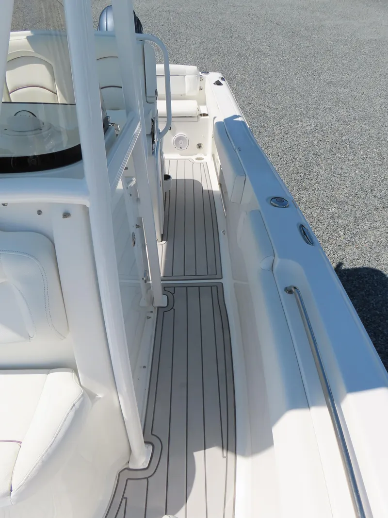 Slide: The Image of 2019 Sea Hunt Ultra 234 boat interior with white seating and sleek deck design. - 14