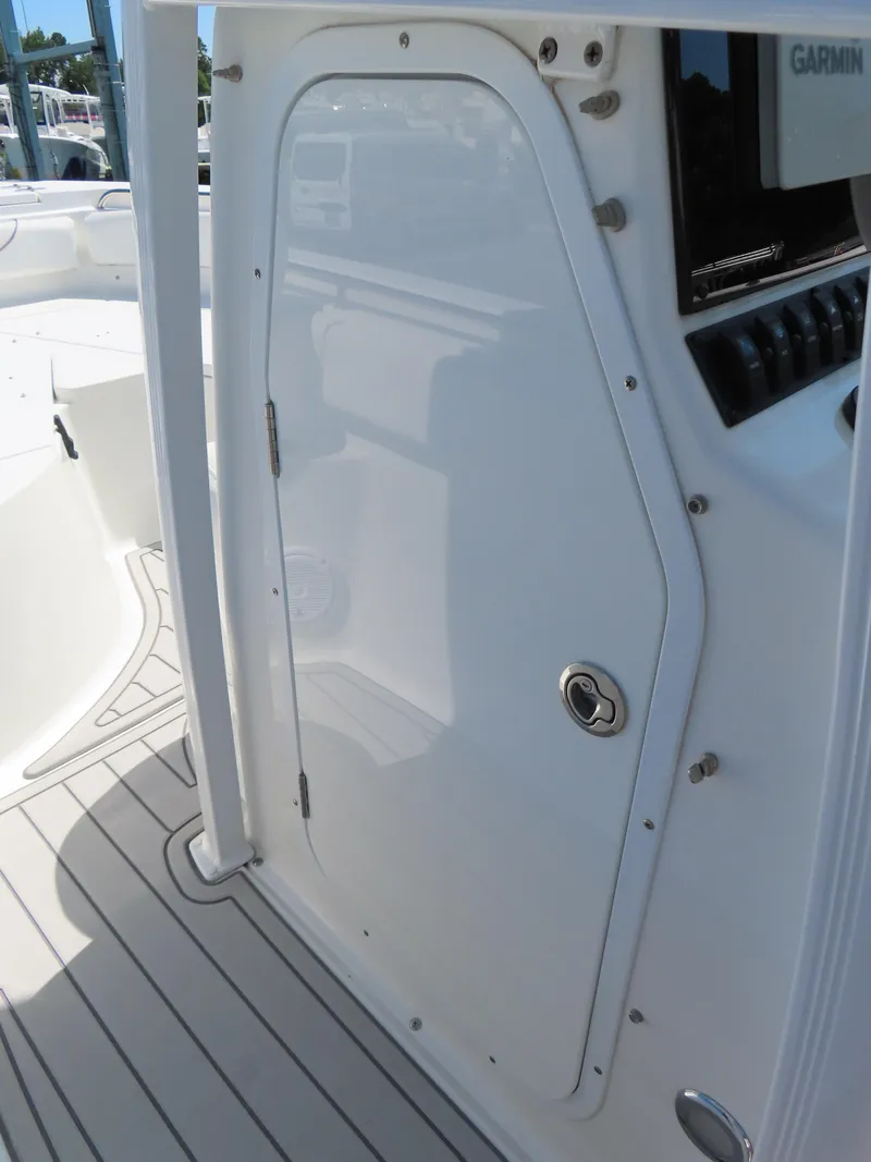 Slide: The Image of 2019 Sea Hunt Ultra 234 boat console with storage compartment and Garmin electronics. - 17