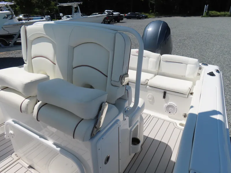 Slide: The Image of 2019 Sea Hunt Ultra 234 boat interior with white cushioned seating and sleek design. - 19
