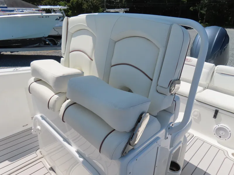 Slide: The Image of 2019 Sea Hunt Ultra 234 boat seating with white cushioned seats and armrests. - 20